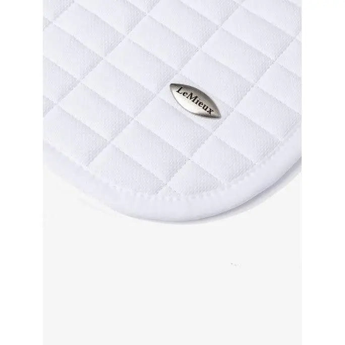 White quilted lemieux self-cool close contact square arctic white saddle pad with silver oval brand emblem