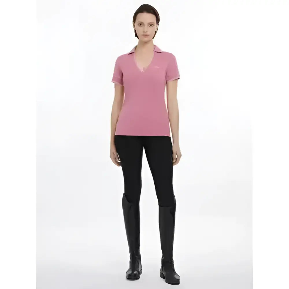 A soft pink lemieux serena sports polo shirt with a subtle v-neckline and short sleeves in smooth cotton fabric