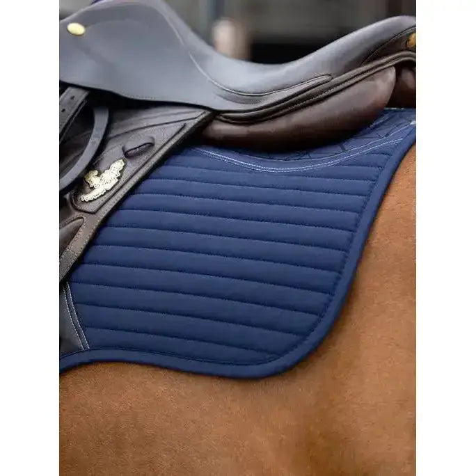 Navy blue lemieux soft shell anti slip close contact square saddle pad with vertical quilting and white edge seam