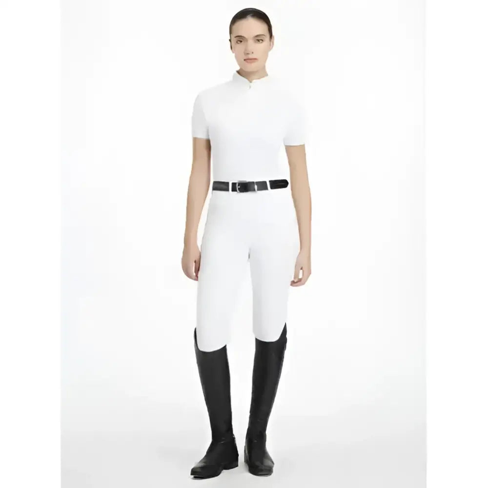 White lemieux sophia short sleeve riding pants with sleek fit and black belt perfect for show jumping or dressage