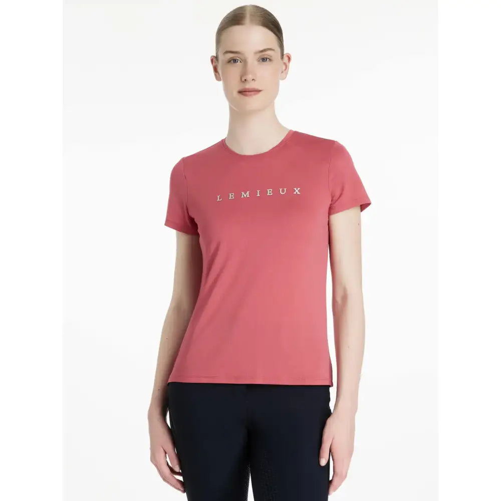 A coral-colored lemieux sports t-shirt with short sleeves and a subtle logo perfect for equestrian use