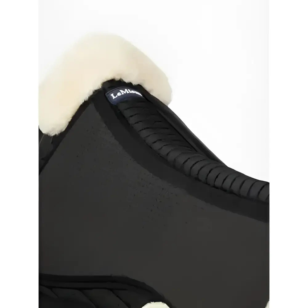Black lemieux streamline half pad with plush white fleece trim and saddle fit logo on natural black strap