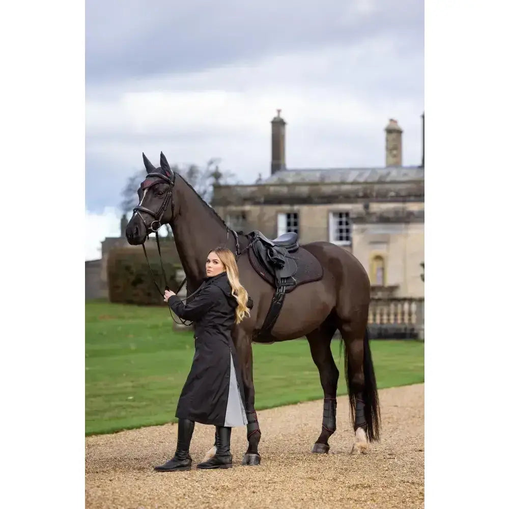 Black leather lemieux suede close contact square cinder saddle with silver hardware and black seat pad on dark brown horse