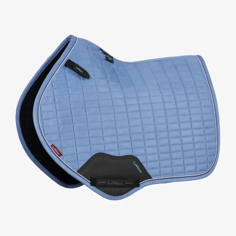 Light blue quilted lemieux suede close square powder blue saddle pad with black trim and branded patches