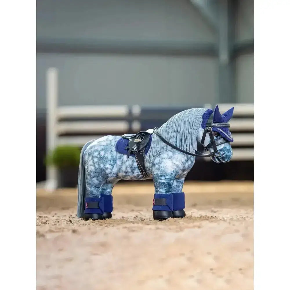 A blue and white lemieux toy pony figurine wearing pony bandages ink navy fleece luxury bandage with black saddle