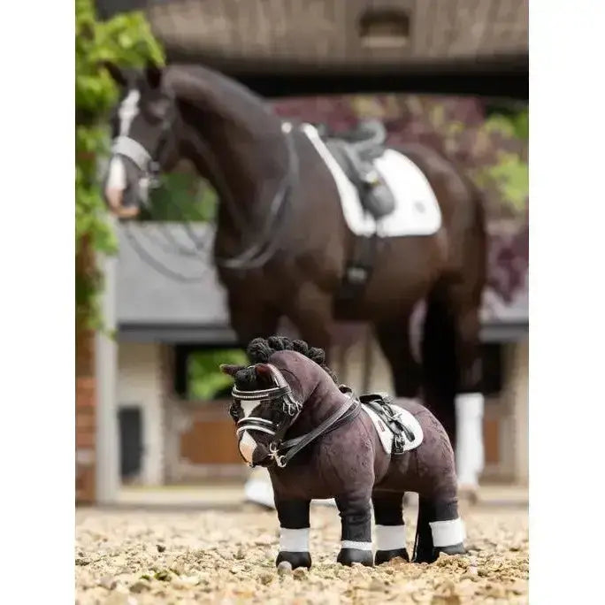 Dark brown plush lemieux toy pony with black mane and white markings wearing a detailed pony double bridle black