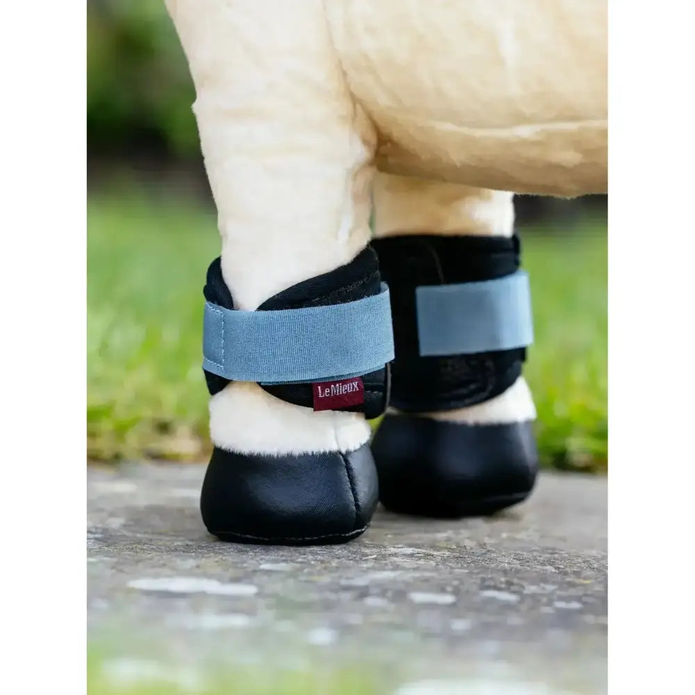 Black leather lemieux toy pony grafter boots with light blue elastic straps and white fleece lining grafter boots ice blue