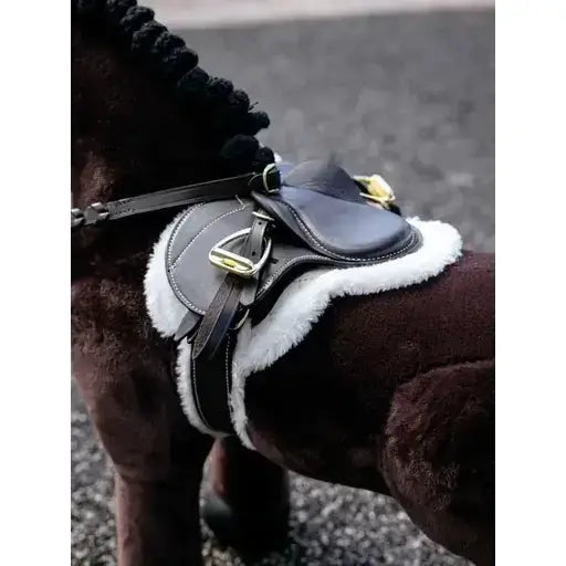 Black leather lemieux toy pony hunter saddle with white shearling lining and gold metal hardware