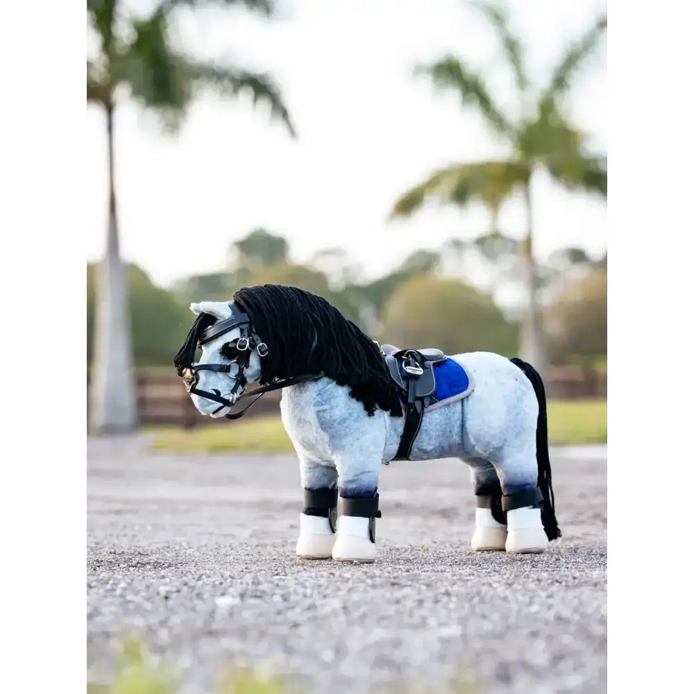 A plush gray and white lemieux toy pony with black mane tail and pony jump saddle plus stud girth black details