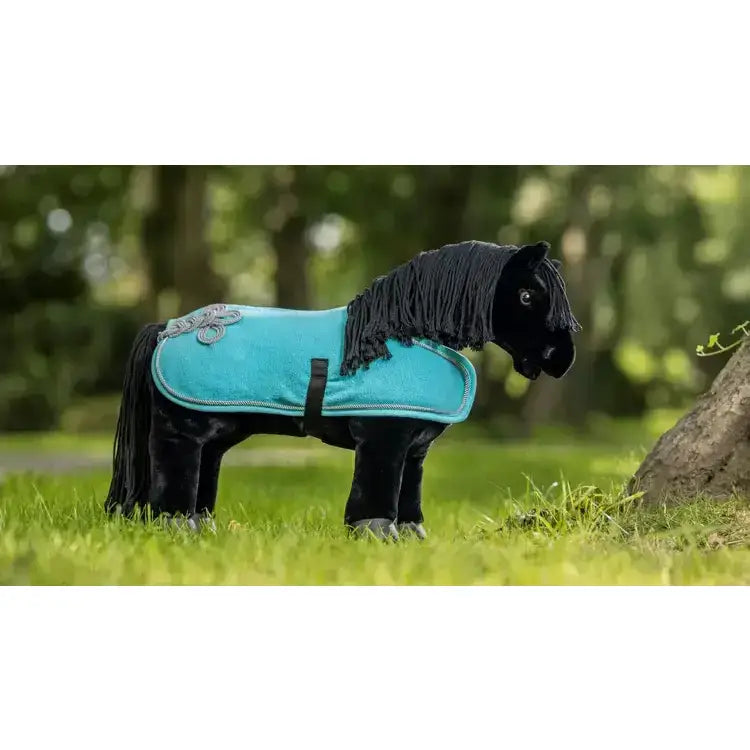 Black plush lemieux toy pony wearing turquoise velour saddle pad with silver embroidery and black fringe pony rug azure
