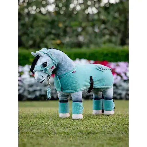 A plush teal lemieux toy pony wearing a matching fleece pony rug lagoon with leg wraps and black straps