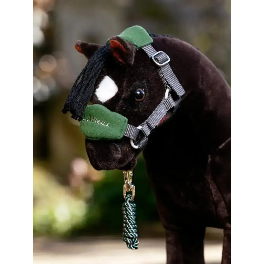 Dark brown plush lemieux toy pony wearing a green and gray vogue headcollar and leadrope hunter green harness