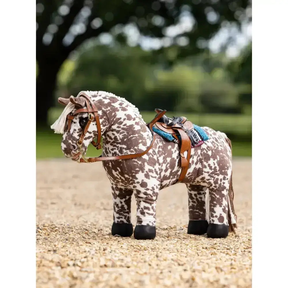 Brown and white spotted lemieux toy pony with authentic miniature western pony western saddle and leather bridle