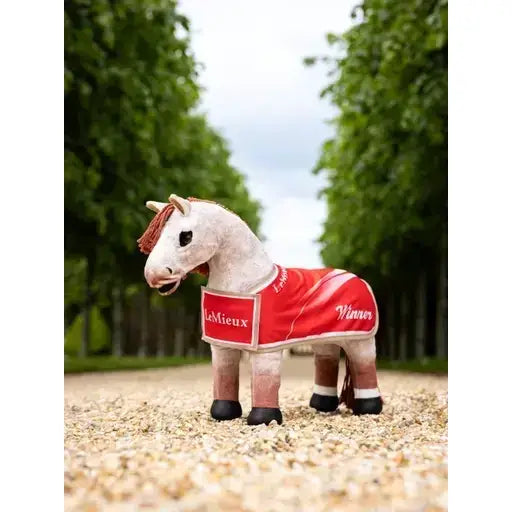 A white lemieux toy pony figurine wearing a winners rug red blanket with lemieux and winner embroidered in white