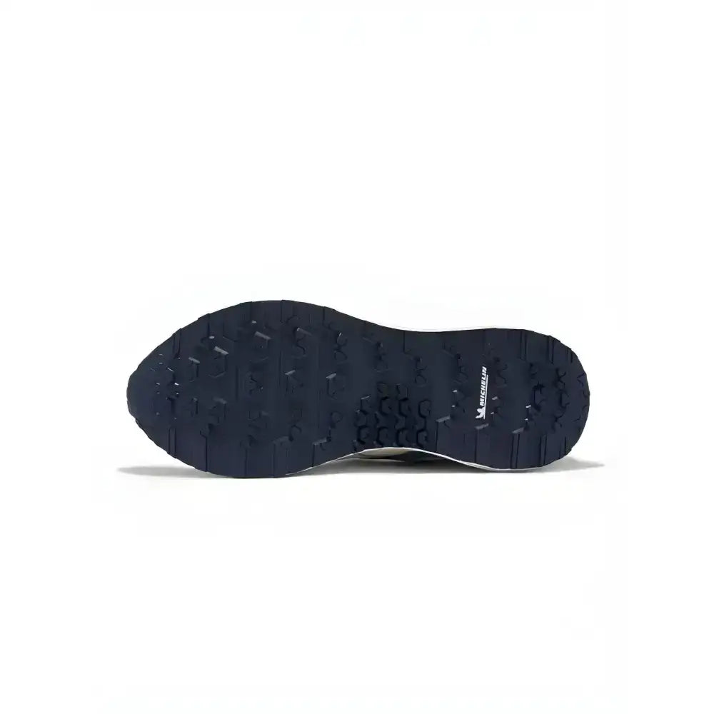 Black rubber sole of lemieux trax 2.0 waterproof trainers petrol with textured tread and michelin logo side view