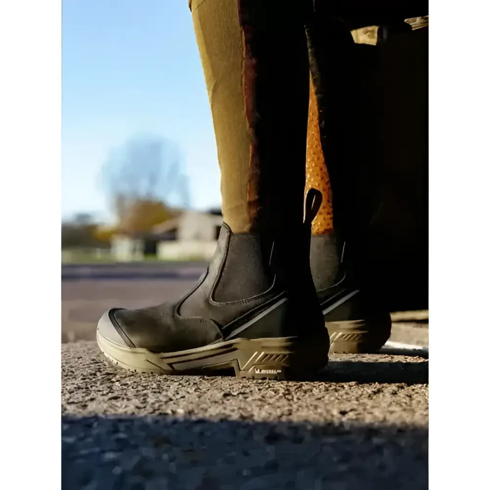 Black lemieux trax waterproof chelsea boots with rugged design, gray sole accents, and stirrup-friendly heel