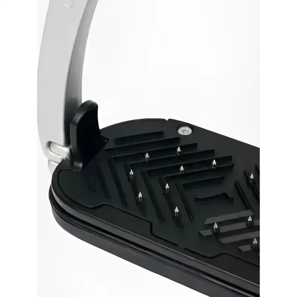 Black plastic horse saddle pad with silver studs and white lemieux vector control stirrup strap made from aviation grade aluminium with impressive strength to weight ratio