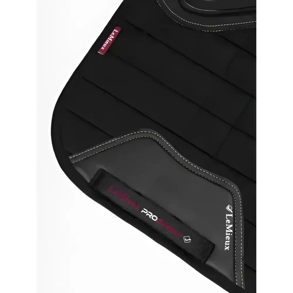 Black quilted silicone dressage square saddle pad with gray stitching and iconic lemeieux cut to ensure saddle stability