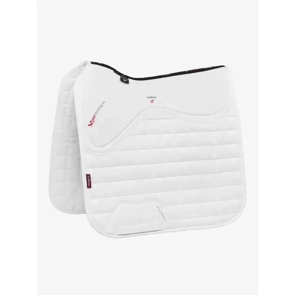 White quilted horse saddle pad with black trim and red branding featuring x-grip silicone design for saddle stability
