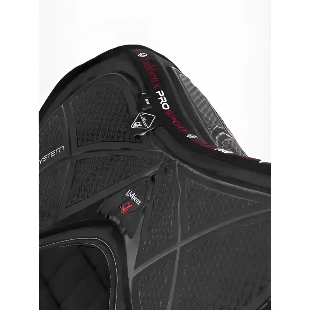 Black protective riding vest with textured panels and red branding featuring x-grip silicone and acavallo gel details