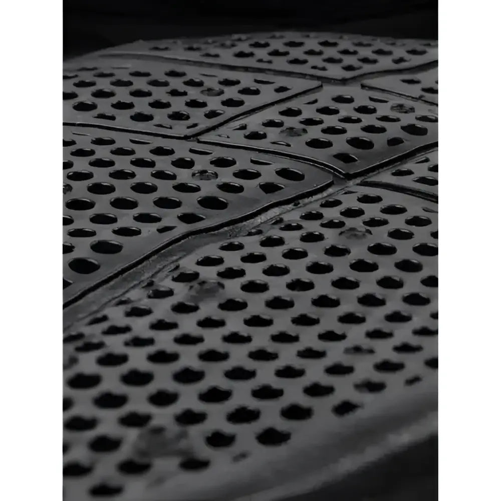 Black rubber floor mat with circular perforations featuring x-grip silicone twin sided texture for dressage use