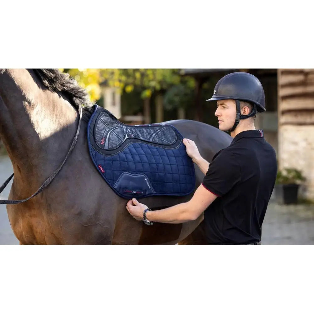 Navy blue quilted saddle pad with x-grip silicone and black mesh panels in the lemieux twin sided eurojump style