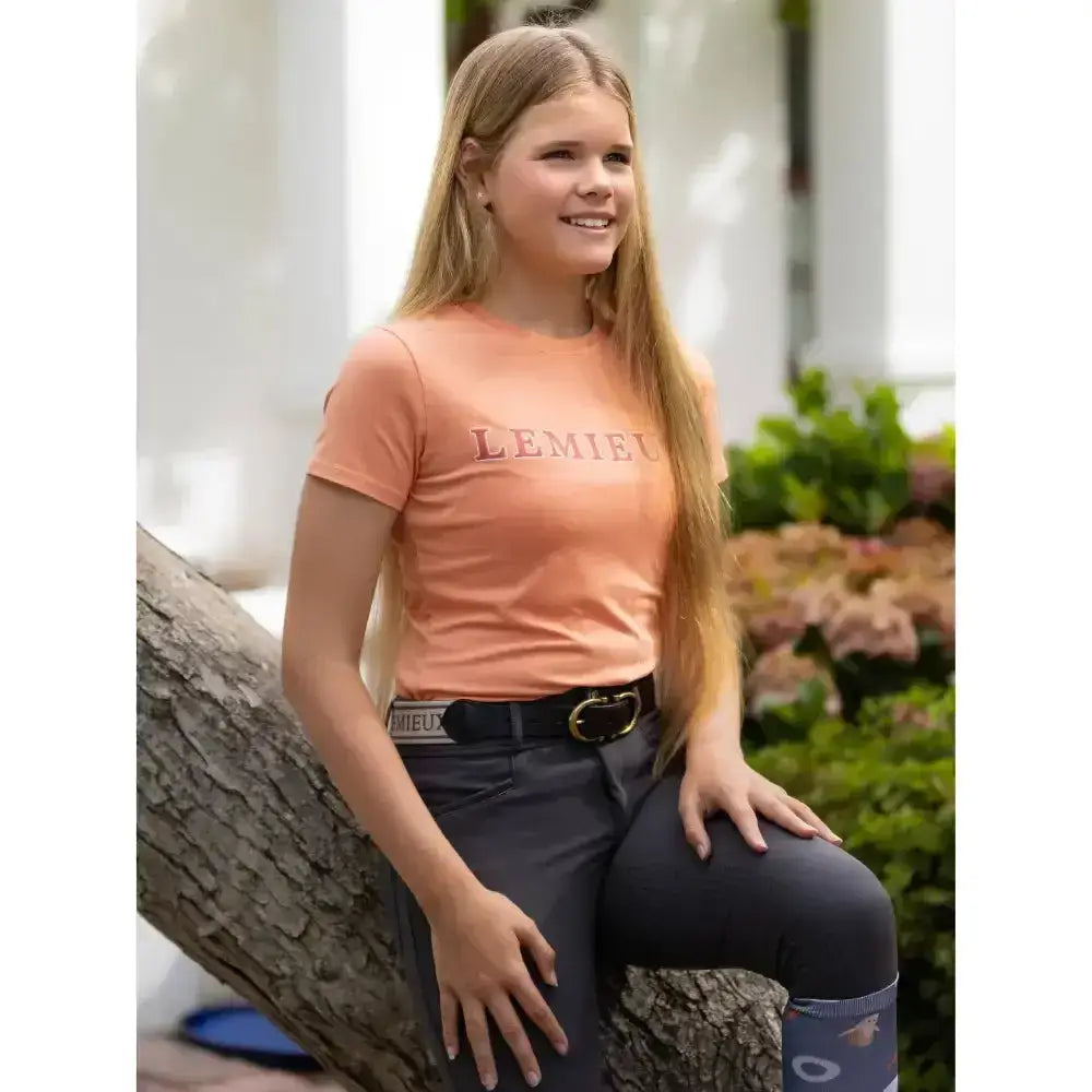 Peach-colored rider arianna t-shirt sherbet with lemieux print across the chest perfect for young riders