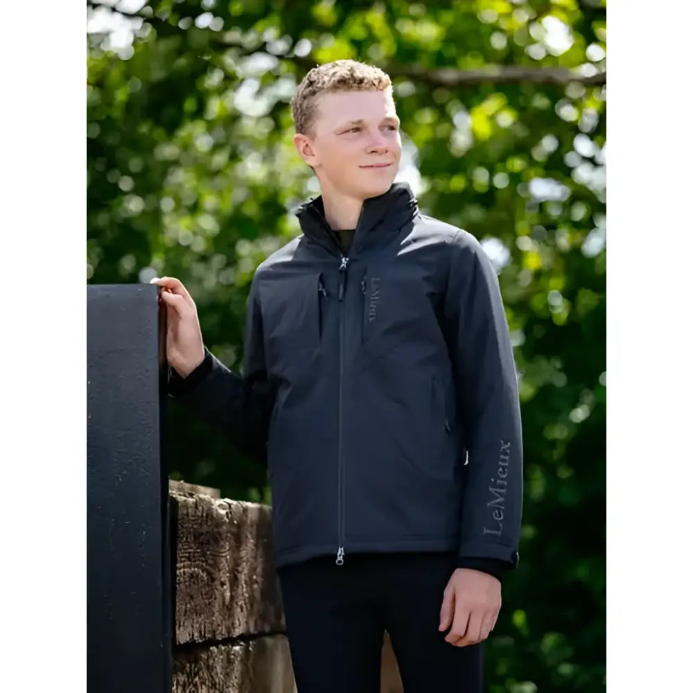 Dark navy lemieux young rider boys waterproof team jacket with subtle brand logo on chest and sleeve