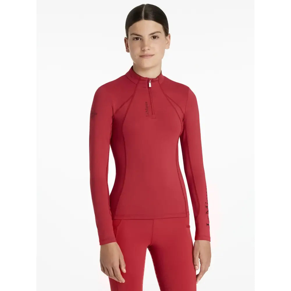 Red long-sleeved performance top with half-zip collar and paneling in lemieux young rider chilli base layer style