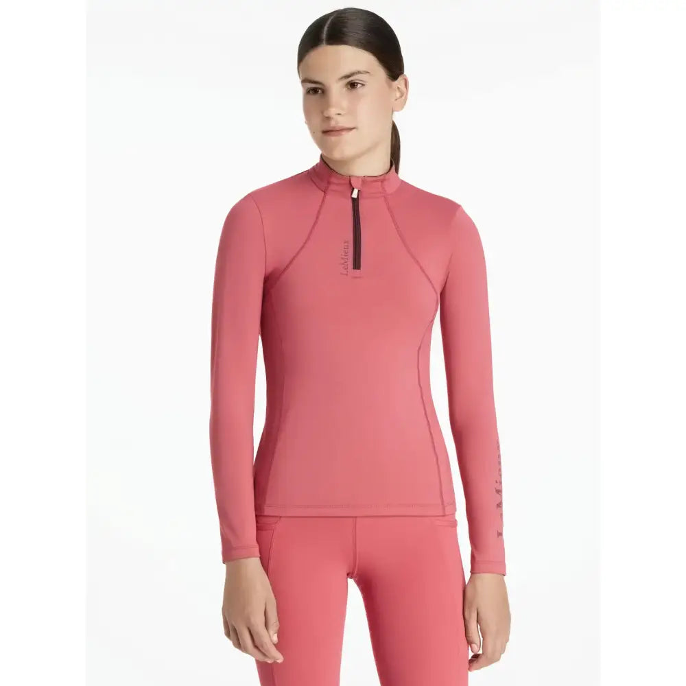 Coral pink long-sleeved athletic top with quarter-zip and seams in lemieux young rider classique cranberry layer
