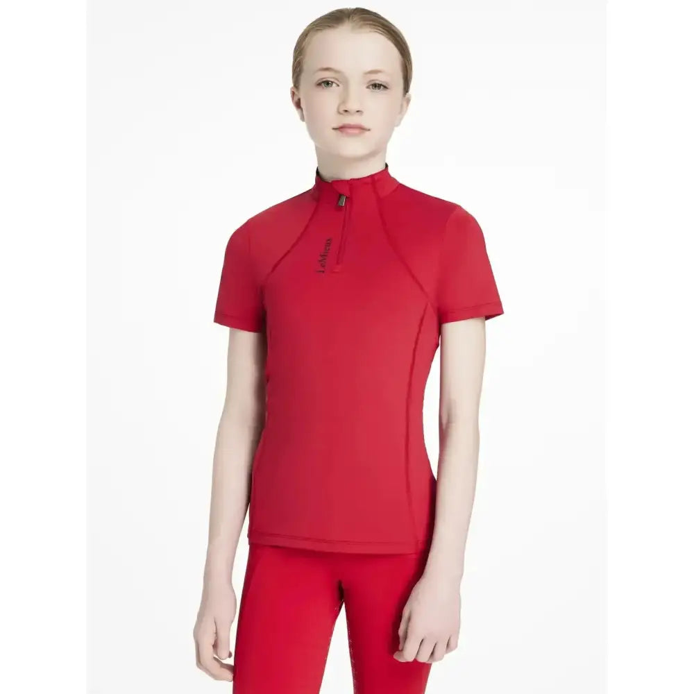 Red short sleeve athletic top with high collar and zipper detail from lemieux young rider classique base layer