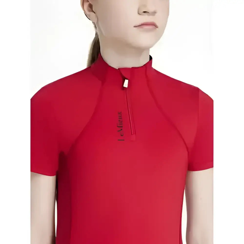 Red short sleeve athletic top with high collar and zipper detail lemieux young rider classique base layer chili