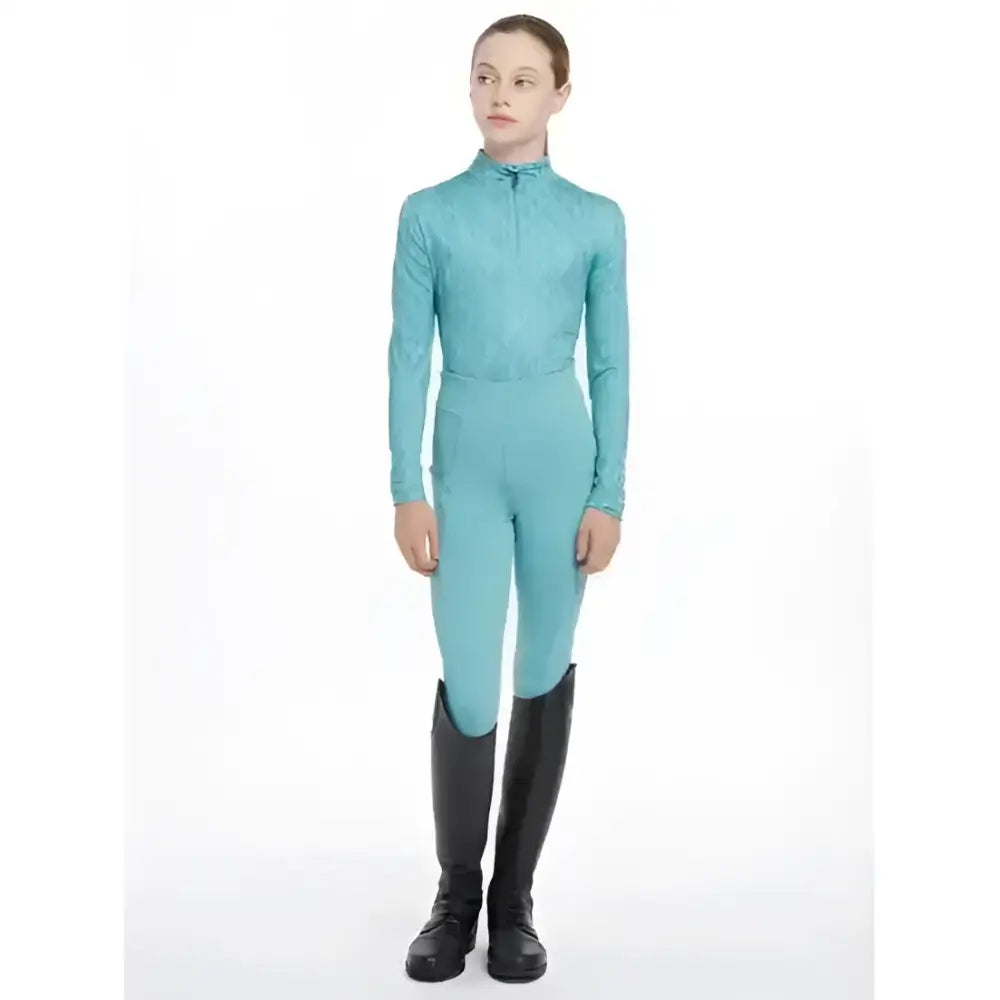 A teal lace lemieux young rider clea base layer with high collar and long sleeves perfect for riding