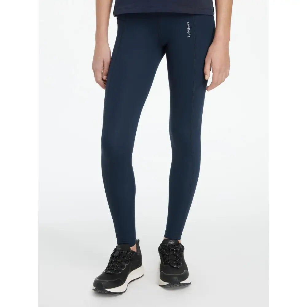 Navy lemieux young rider darla sport legging with sleek form fitting design and subtle logo on the thigh