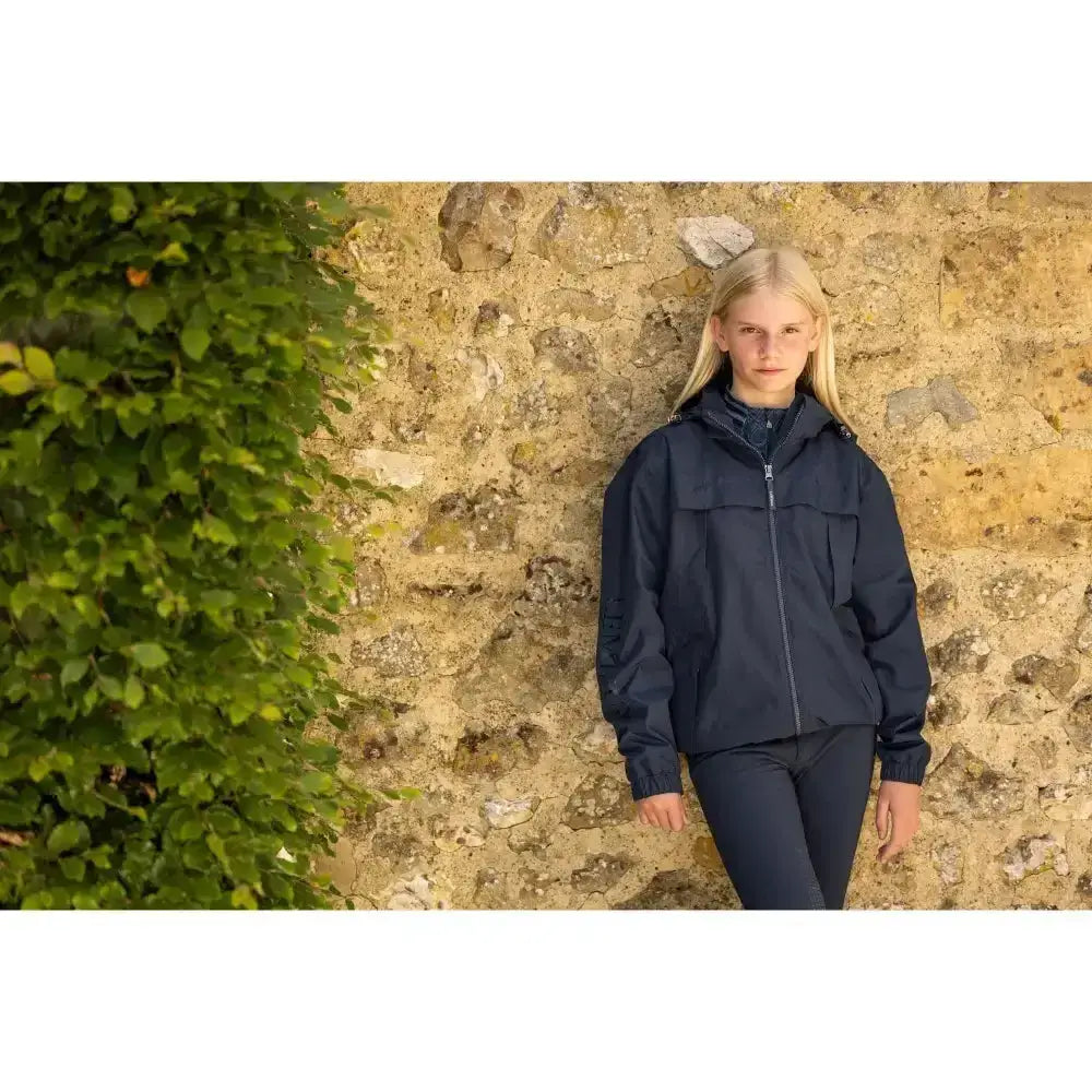 Navy dolcie waterproof jacket with hood and front zipper perfect for lemieux young rider’s wet weather gear