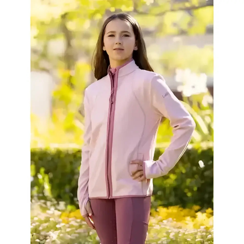 A soft pink lemieux young rider felicity fleece zip through jacket with long sleeves and subtle upper sleeve branding