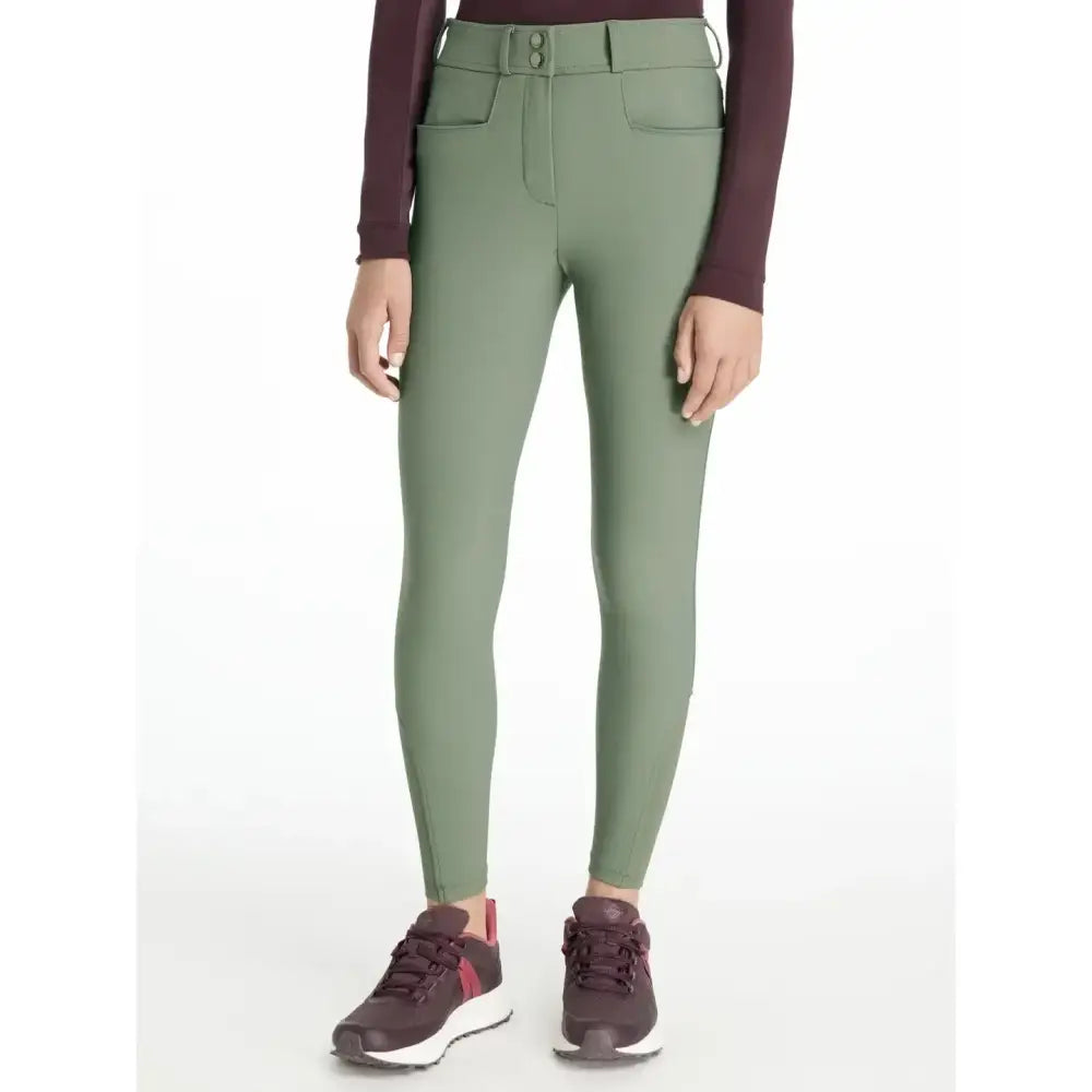Olive green fitted lemieux young rider seat izzy breeches with buttoned waistband and front pockets in rosemary color