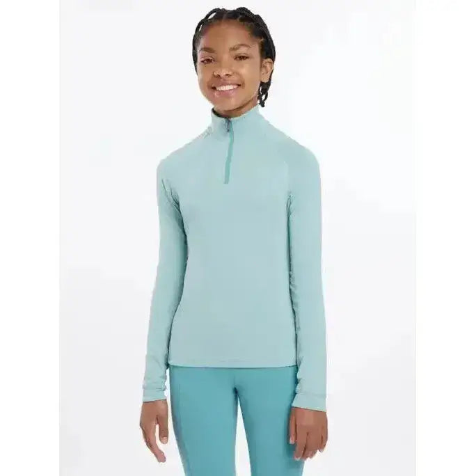 A light blue lemieux young rider hope lightweight base layer with long sleeves and a quarter-zip collar for active use