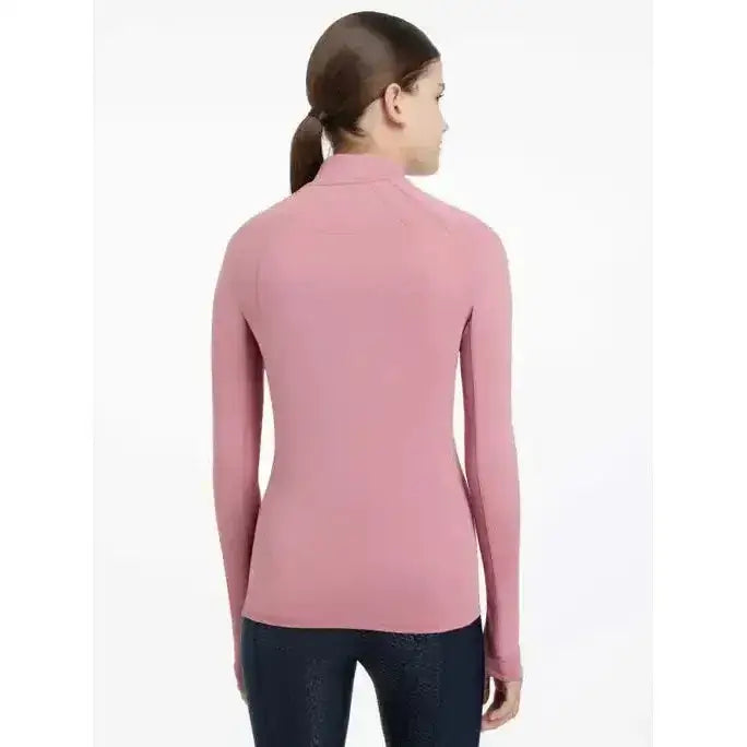 A soft pink lemieux young rider hope base layer peony with long sleeves high collar and seamless design