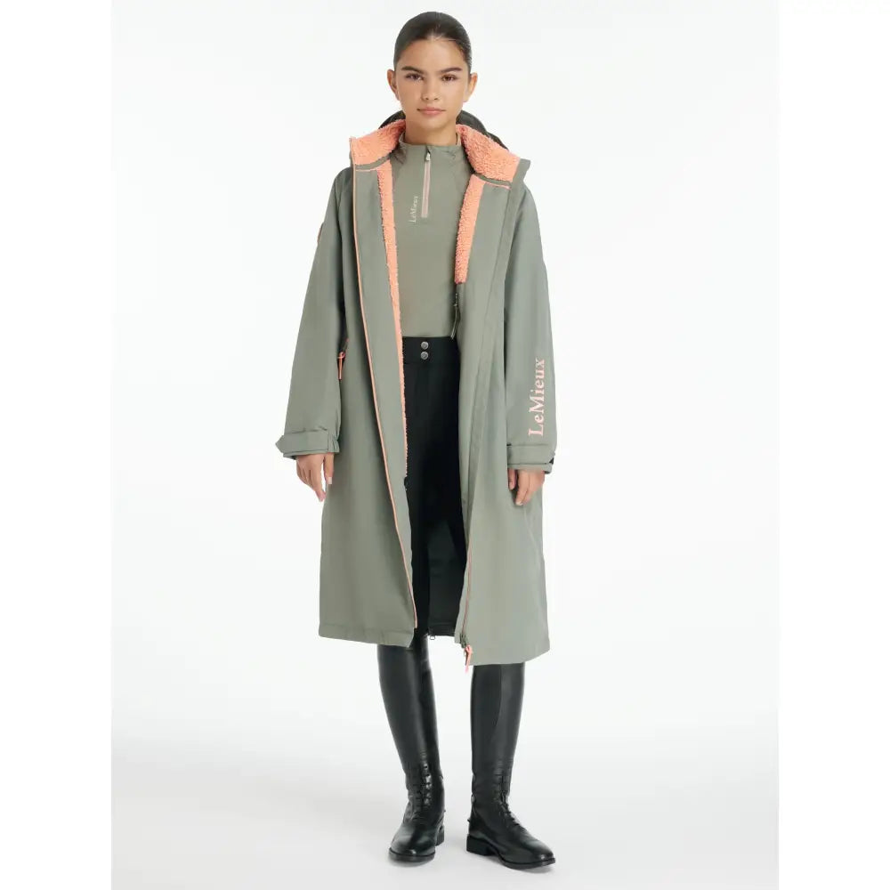 Olive-green lemieux young rider trench coat with plush peach fleece-lined hood and breathable hydroshield robe rosemary fabric