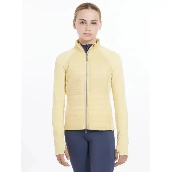 A pale yellow quilted zip-up lemieux young rider josephine jacket mimosa with a high collar and long sleeves