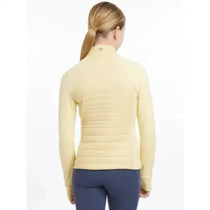 A pale yellow quilted lemieux young rider josephine jacket mimosa with long sleeves and a high collar
