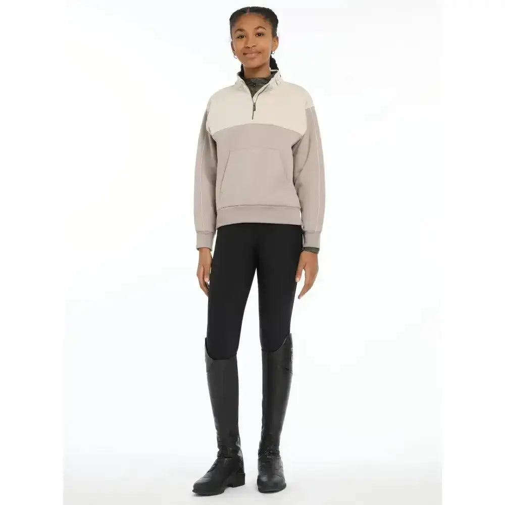 A soft beige and light gray lemieux young rider kate quarter zip sweatshirt with ribbed collar and cuffs