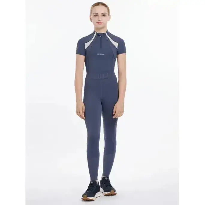 A navy blue lemieux young rider lizzie mesh legging with white shoulder panels and small chest logo in dusk blue