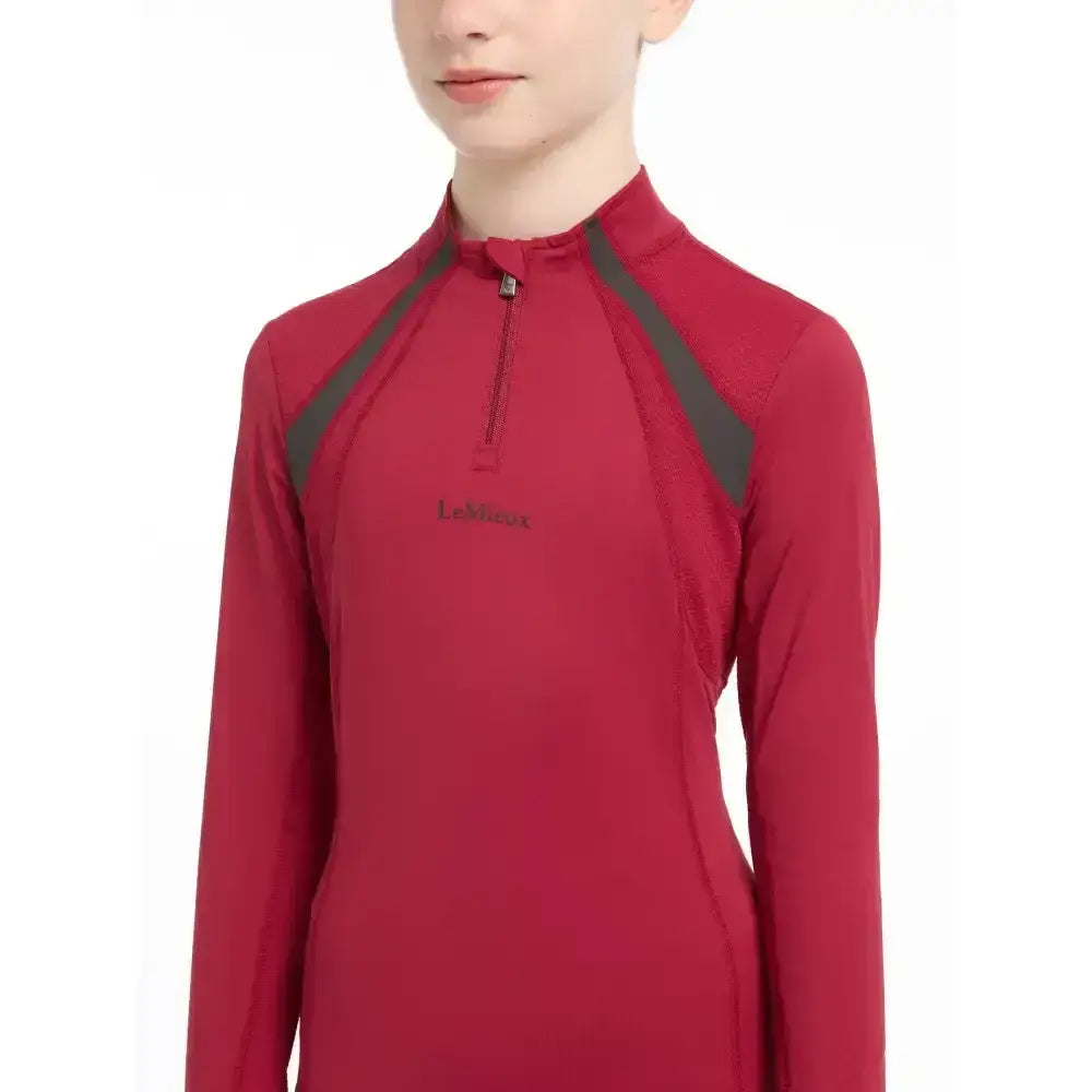 Red long-sleeved lemieux young rider mia mesh base layer with dark gray shoulders and half-zip collar ember color