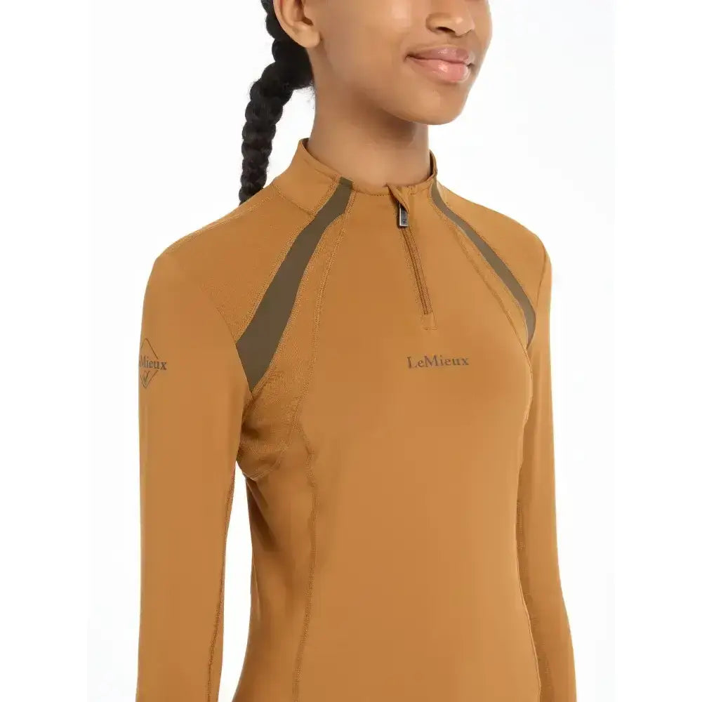 Tan long-sleeve lemieux young rider mesh base layer with olive green accents and half-zip collar young rider mia