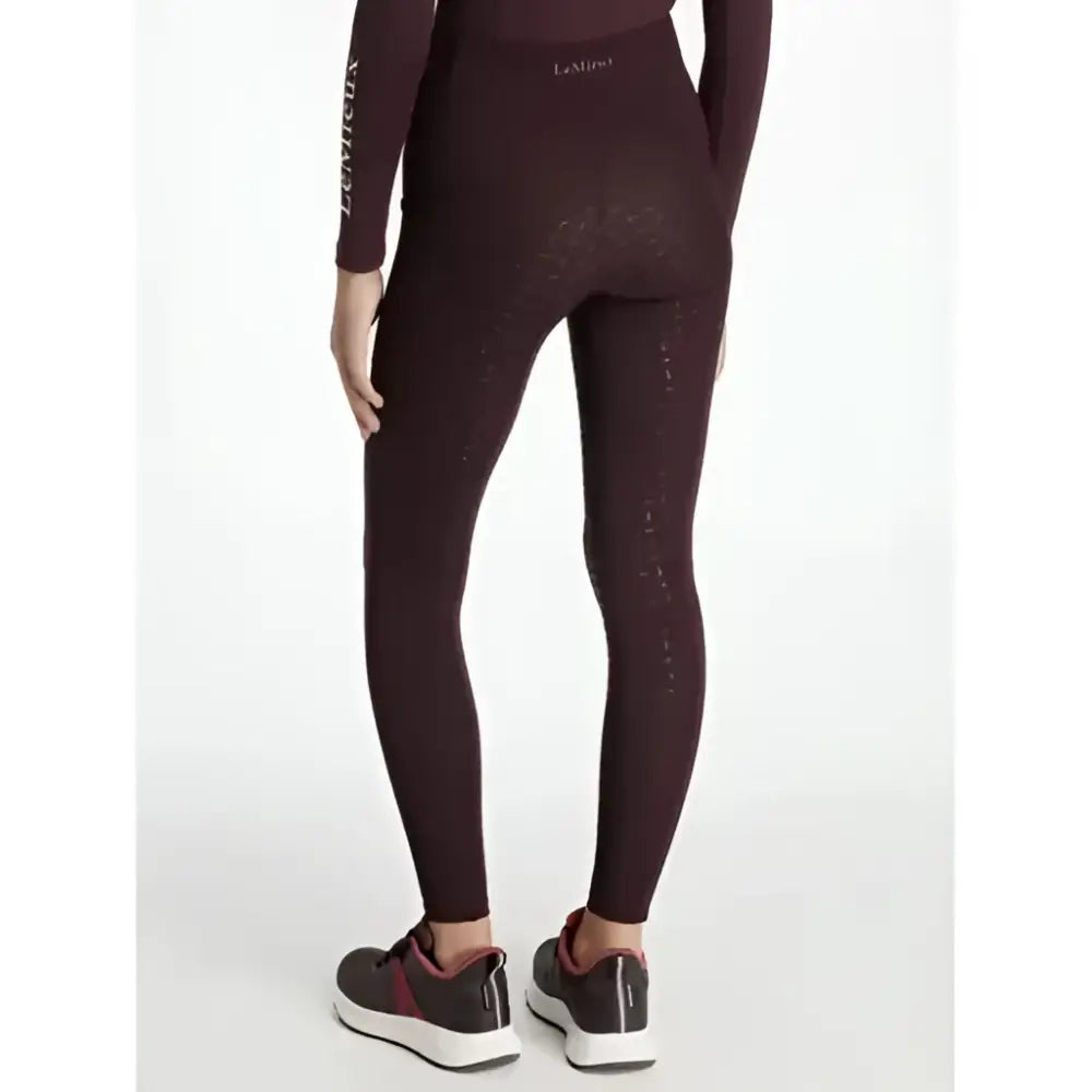 Dark burgundy form-fitting lemieux young rider orla pull ons damson leggings with textured patterns and logo waistband