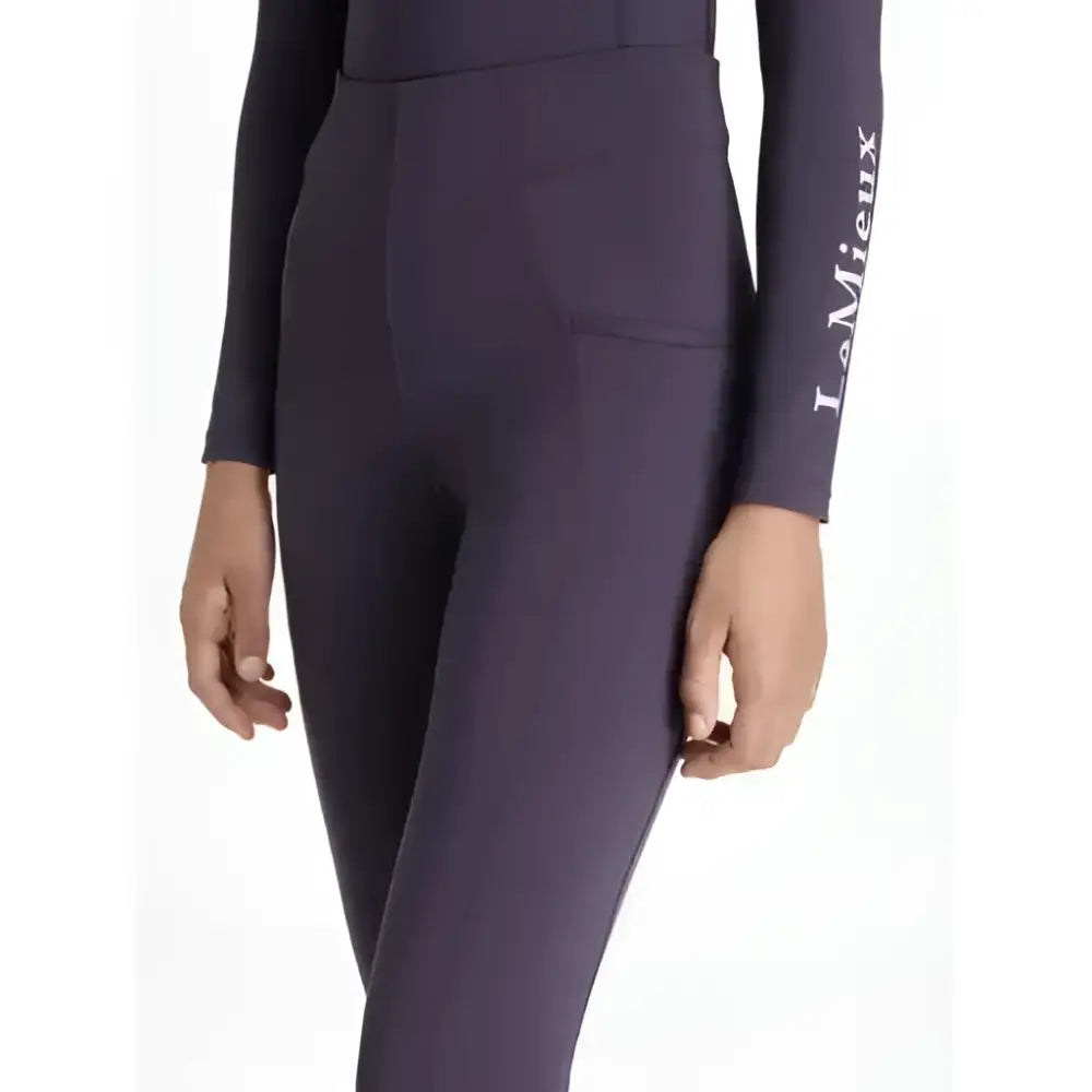 Dark purple form-fitting lemieux young rider orla pull ons with subtle seam detail and lamieux logo on left leg