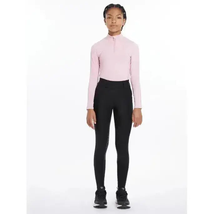 Pink long-sleeved high-neck top paired with lemieux young rider remi breggings black for comfortable riding gear