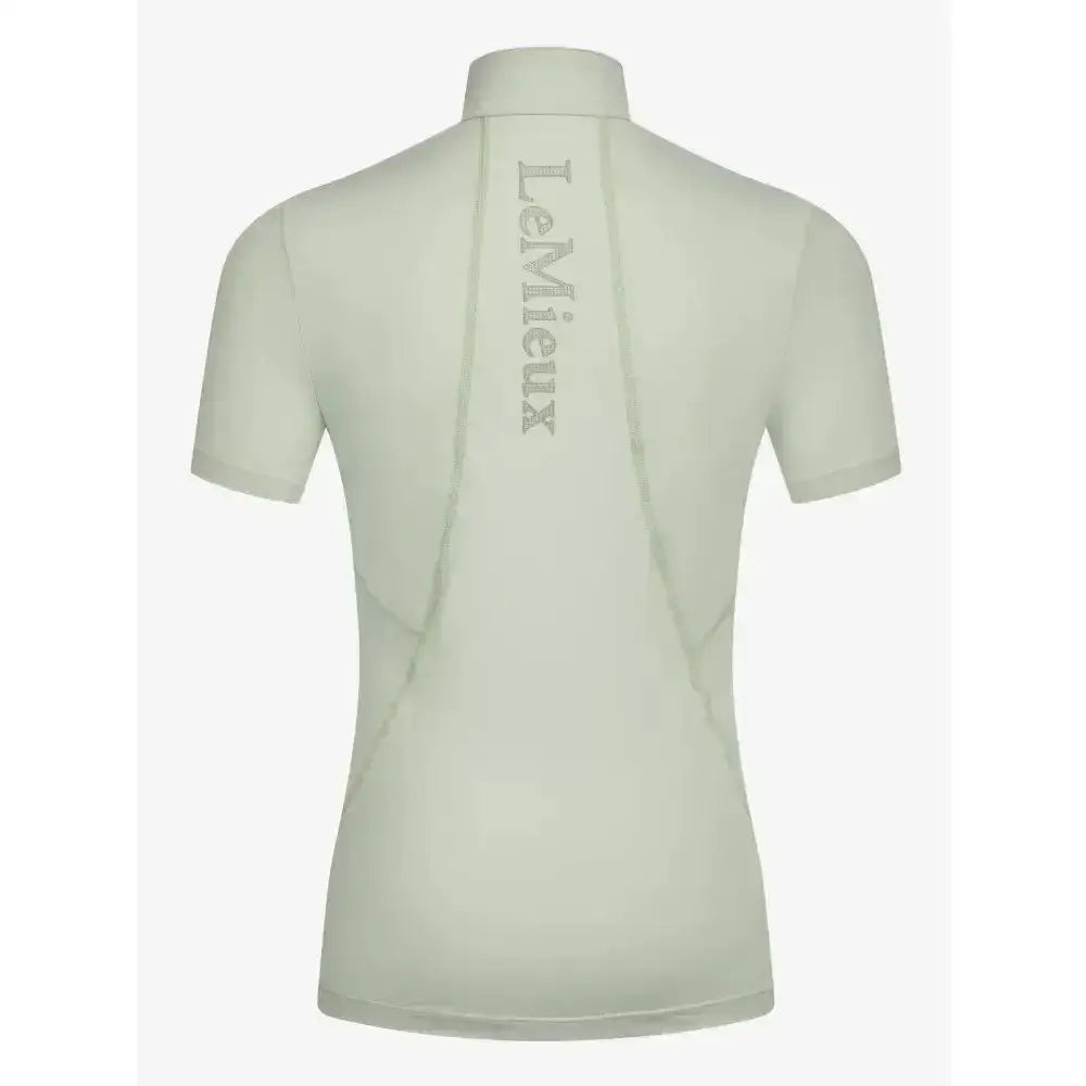 Back view of a pale green lemieux young rider short sleeve base layer pistachio with subtle vertical logo embroidery